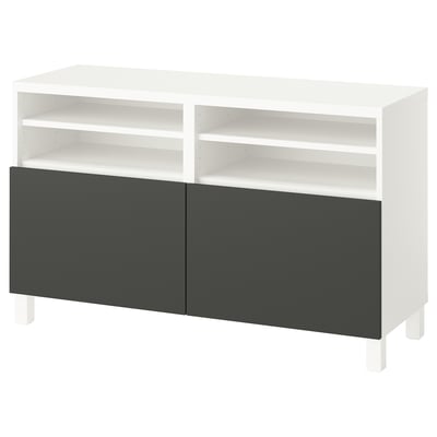 A white BESTÅ tv bench with dark grey doors. It open shelves and a modern design.