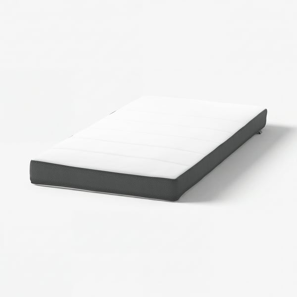 A DRÖMMANDE baby mattress in grey with a white centre, featuring a textured surface and rounded corners.