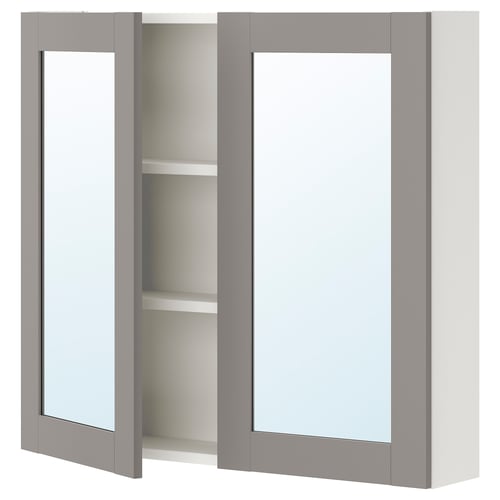 A grey ENHET wall-mounted bathroom cabinet with a mirrored door. The cabinet has a modern design with rectangular mirrors and two shelves inside.