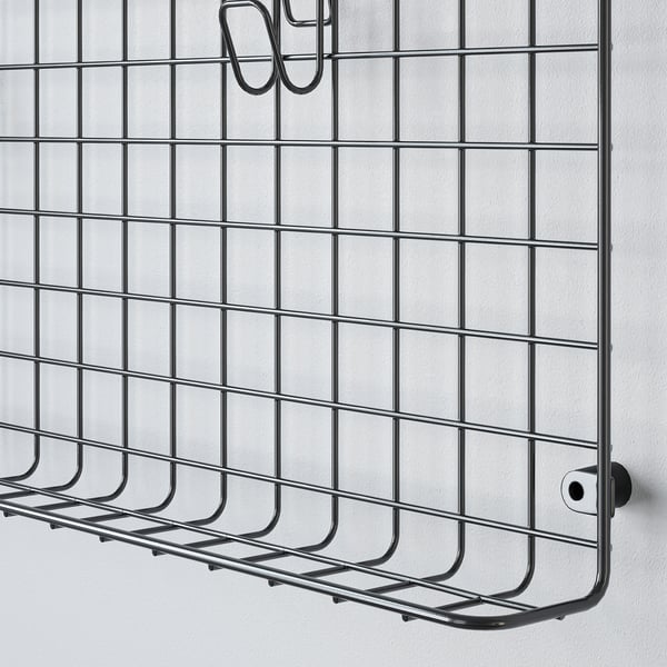 Metal wall-mounted organiser with multiple compartments and hooks, designed for efficient storage.