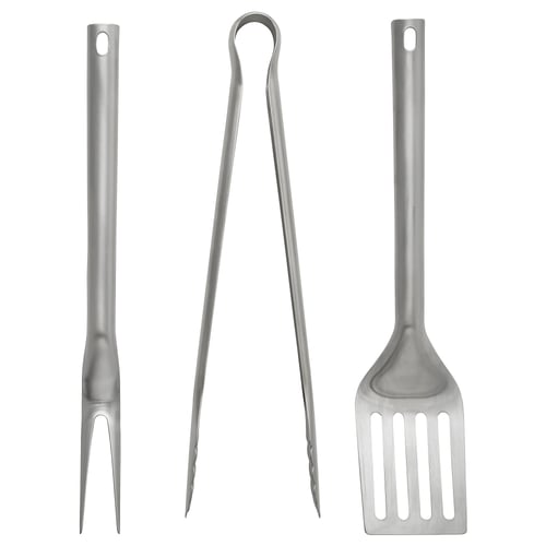 Three stainless steel grilling tools: fork, tongs, spatula with long handles, designed for durability and ease of use.