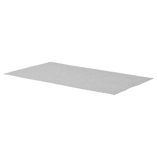 A grey rectangular KOMPLEMENT drawer mat made of polyester, designed to prevent items from sliding.