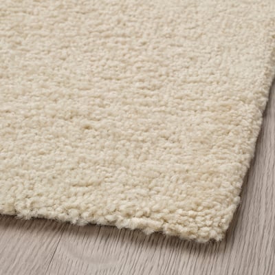 A rectangular, off-white LANDSVÄG rug with a textured, striped pattern. Made of polypropylene and polyester.