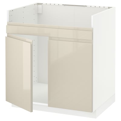 White METOD kitchen base unit with beige gloss doors and integrated handles.