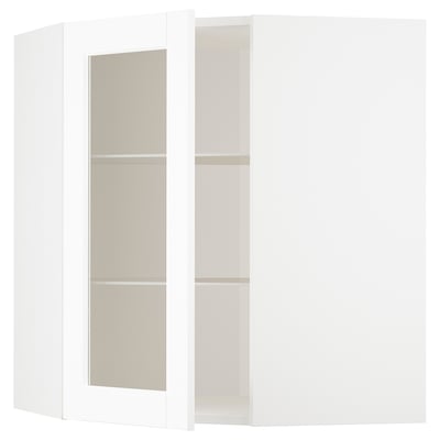 A white ikea METOD kitchen cabinet with glass doors and beige shelves.