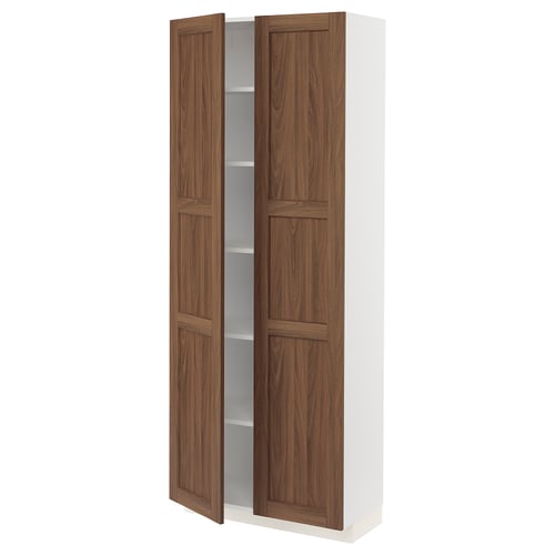 Open white cabinet with walnut doors.