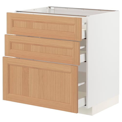 An ikea METOD kitchen cabinet in white with three light wooden drawers. The drawers are handle-less and feature a sleek, minimalist design.