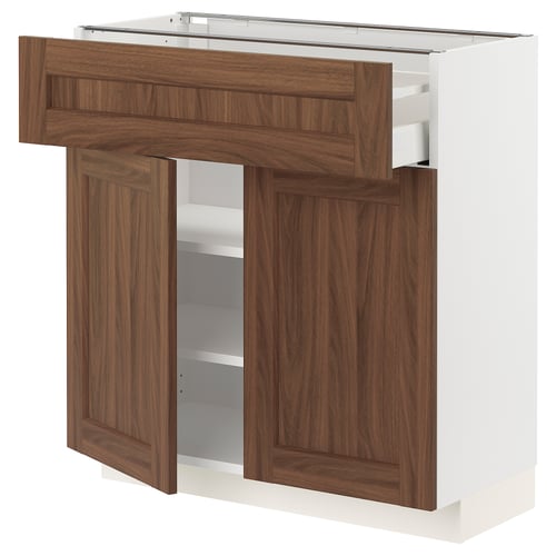 A METOD kitchen unit with walnut wood-effect doors and a white frame. It includes drawers and shelves for storage.