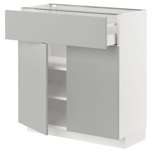 White ikea METOD kitchen unit with grey drawer and shelves.
