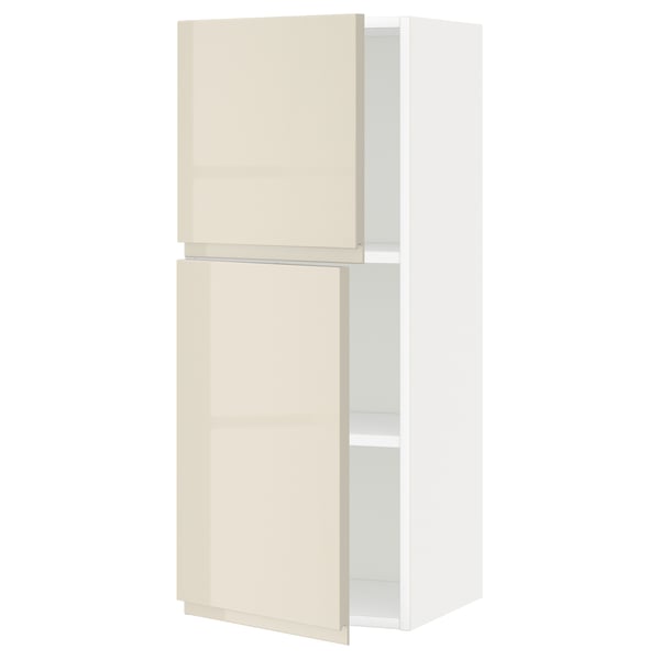 A modern METOD wall cabinet in high gloss beige with integrated handles.