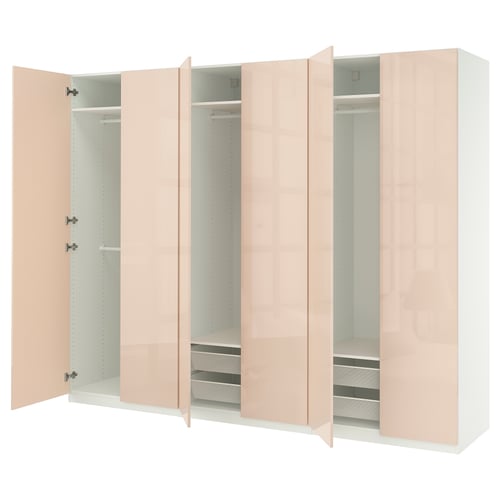 Modern light pink PAX wardrobe with open doors showing shelves and drawers.