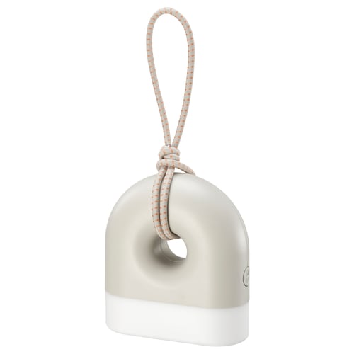 A SOLVINDEN lamp, white and grey, shaped like a donut with a handle. Its designed for both indoor and outdoor use.