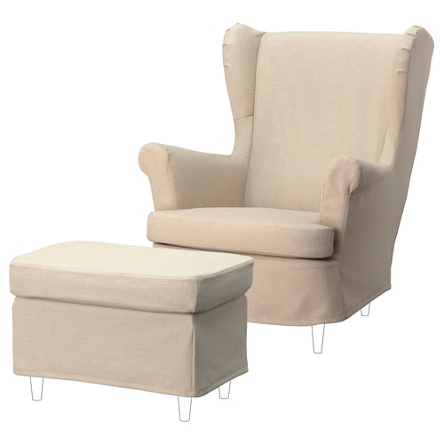 A beige STRANDMON chair with a matching footstool, both upholstered in 100% recycled polyester fabric. The chair high winged backs and rolled arms.