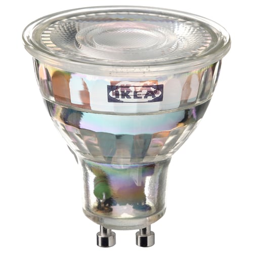 A TRÅDFRI smart light bulb, clear glass, round shape, with a metallic base. Brand label visible on the body.