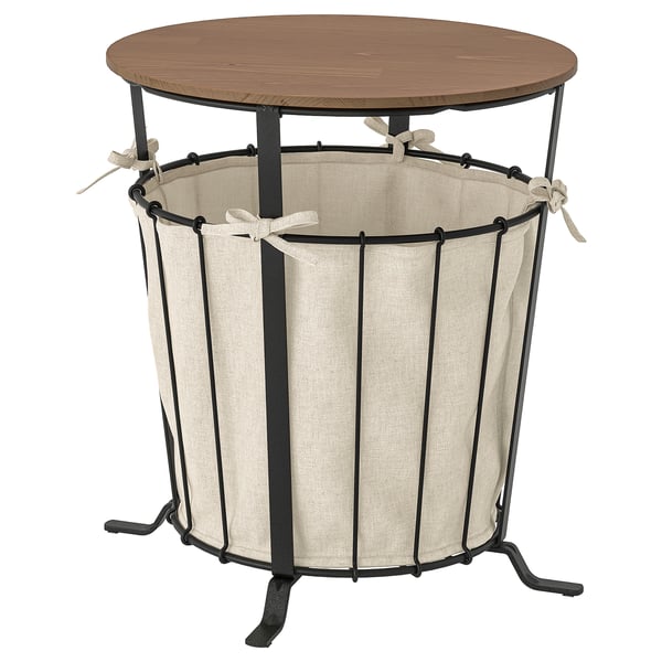 Ängsby Aufbewahrungstisch mit runder Holzplatte, schwarzem Metallgestell und beiger Stofftasche.