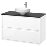 Moderner weißer Wandschrank für das Badezimmer mit schwarzer Arbeitsplatte und rundem Waschbecken.
