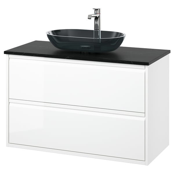 Ein moderner weißer Waschtisch mit einem dunkelgrauen Waschbecken aus Glas. Der Schrank hat zwei Schubladen und ein schlankes, minimalistisches Design.