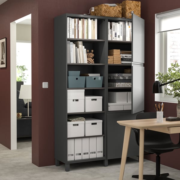 Modernes Homeoffice mit BESTÅ-Regal, Büchern und roten Wänden.