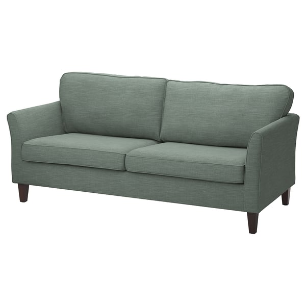 Grünes EKHOLMA Sofa mit Holzbeinen und Plüschkissen.