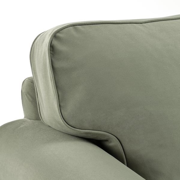 Sofa mit Kissen, gepolstert mit grünem Stoff. Dicke, bequeme Kissen, hochwertiges Design.