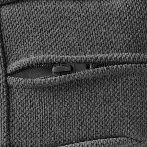 Nahaufnahme eines strukturierten Stoffes mit Reißverschluss, der Nähte und Materialdetails zeigt.