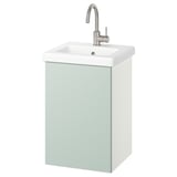 Ein hellgrüner Wandschrank mit weißem Waschbecken und silbernem Wasserhahn.