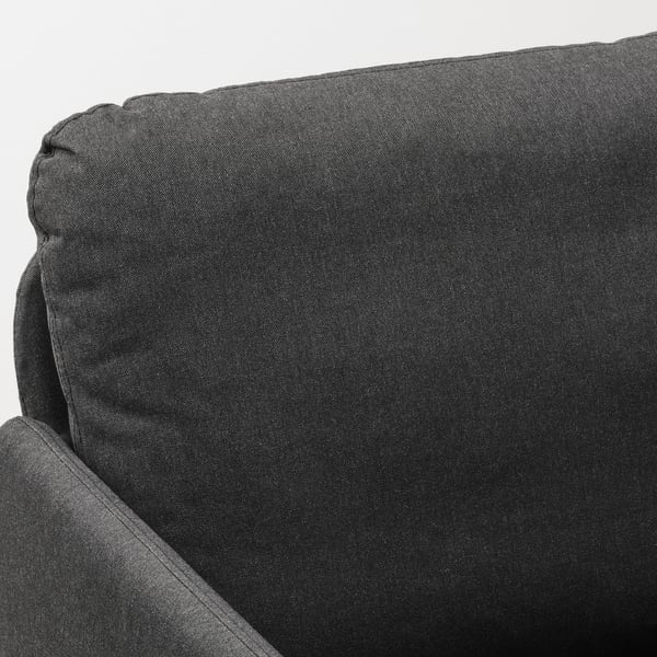 Eine schwarze GLOSTAD-Sofaecke, die das schlanke Design und den hochwertigen Stoff mit robusten Kissen und sauberen Nähten für Langlebigkeit veranschaulicht.