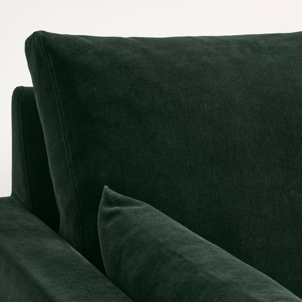 Dunkelgrüne Rückenlehne des Sofas, glatte Textur, klare Linien, einladender Komfort.