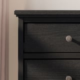 Kommode aus schwarzem Holz mit glatten, runden Griffen. Schlichtes, modernes Design.