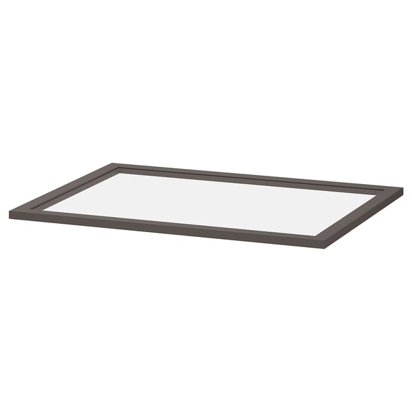 Ein dunkelgraues KOMPLEMENT Glasregal mit einem Rahmen aus Faserplatten und gehärtetem Glas, das für eine einfache Betrachtung und Aufbewahrung in einem Schrank konzipiert ist.