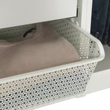 Weißer Garderobenkorb mit geometrischem Design hält gefaltete Kleidung und fördert die Luftzirkulation.