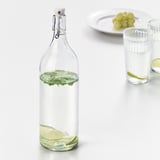 Glasflasche mit Limettenscheiben und Minze, versiegelter Verschluss.