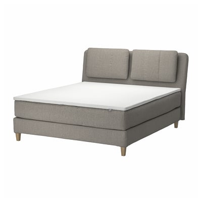 Modernes graues Stoffbett mit Kissen, Holzbeinen und weißer Matratze.