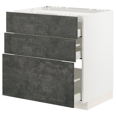 Moderner Küchenschrank aus dunkelgrauem Beton mit drei großen Schubladen.