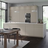 Moderne Küche mit grauen Schränken, Edelstahlgeräten und Inseltisch.
