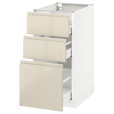 METOD Küchenzeile mit hochglänzenden beigen Schubladen, schlankem Design, drei Schubladen, weißem Sockel.