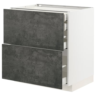 Ein moderner, weißer METOD-Küchenschrank mit dunkelgrauen Schubladen in Betonoptik in einem schlanken, rechteckigen Design.