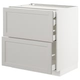 Ein weißer METOD Küchenschrank mit zwei Schubladen und einem ausziehbaren Regal.