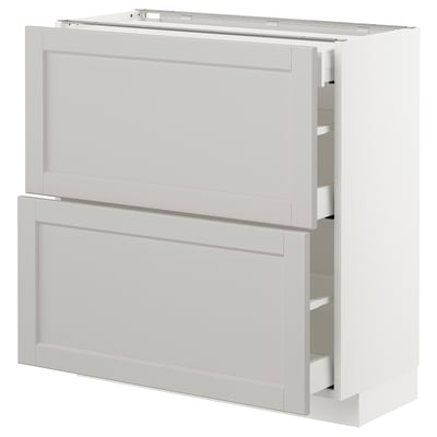 Ein weißer METOD-Küchenschrank mit zwei Schubladen und einer Tür, in klassischem Design mit abgeschrägten Kanten.