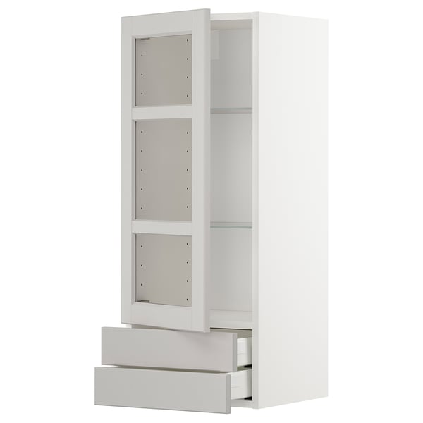 Weißer METOD-Küchenschrank mit Glasböden und Schubladen.
