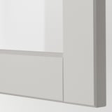 Nahaufnahme eines modernen Küchenschranks mit schlanker, abgeschrägter Glastür und robustem Rahmen, der die handwerkliche Qualität zeigt.