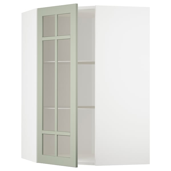 Ein grüner METOD-Eckschrank mit Glastüren und verstellbaren Regalen.