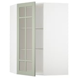 Ein grüner METOD-Eckschrank mit Glastüren und verstellbaren Regalen.