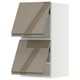 Moderner Küchenschrank in Beige mit glänzender Oberfläche, schlankem Design und integrierten Griffen.