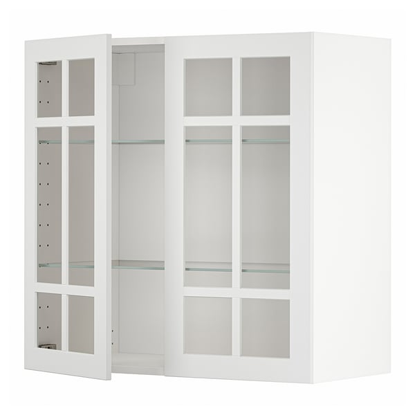 Weißer METOD-Küchenschrank mit Glastüren und Regalen.