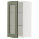 Wandschrank mit grüner Glastür und weißer Innenseite.