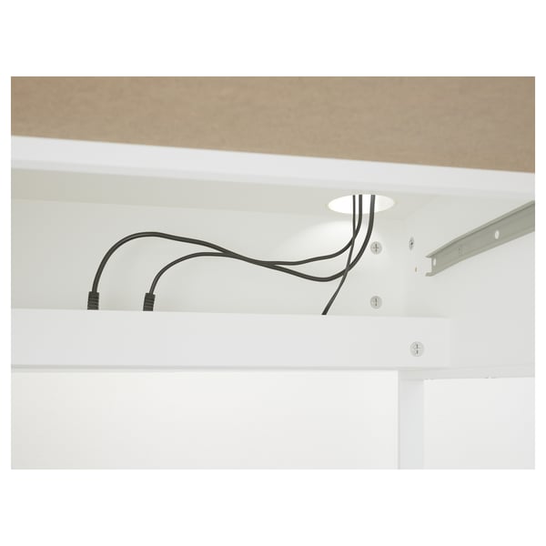 Kabelmanagementsystem im White Desk, das Kabel sauber durch die dafür vorgesehenen Löcher führt.