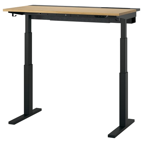 Der Sitz-Steh-Schreibtisch MITTZON. Er ist rechteckig mit einer hellen Holzplatte und schwarzen Metallbeinen und verfügt über einen höhenverstellbaren Mechanismus.