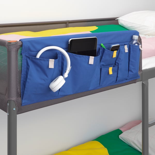 Blauer Betttaschen-Organizer bietet Platz für Telefon, Kopfhörer und Wasserflasche auf dem Etagenbett.