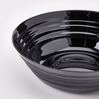 Schwarz glasierte Keramikschale mit kreisförmigem Wellendesign.